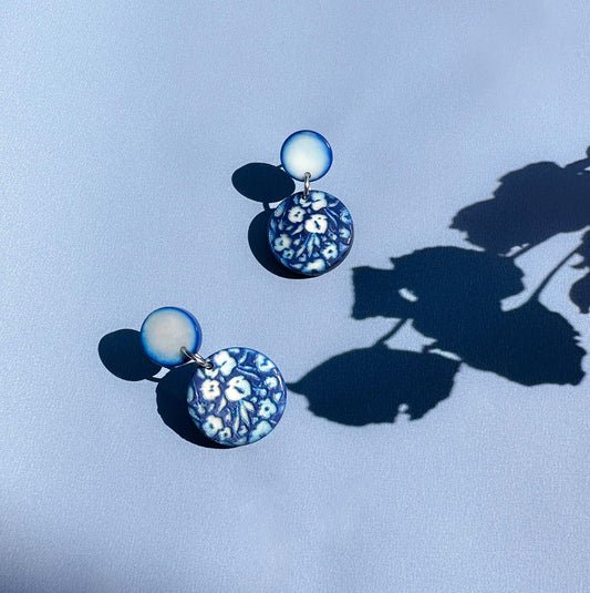Pair of earrings with floral engraved design made with tagua nut beads.