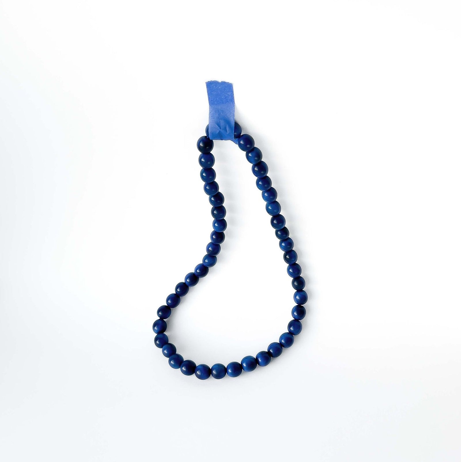 Blue beaded tagua necklace on a white background